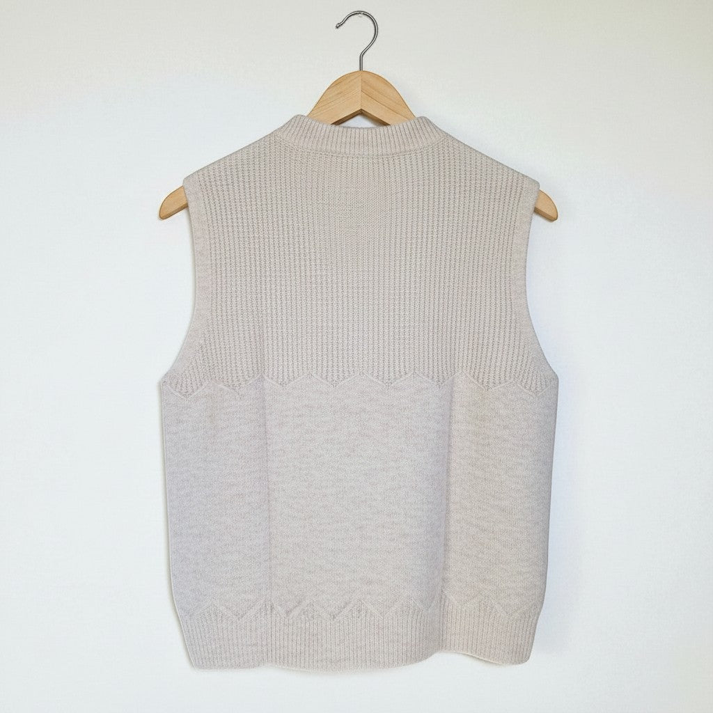 La Vie Continue beige knit vest with mock neck and textured yoke. Soft alpaca blend.