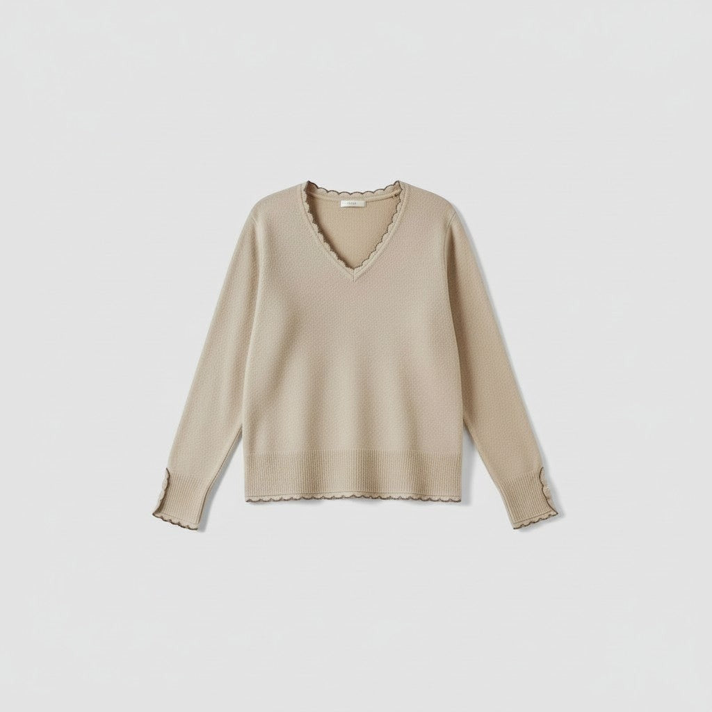 La Vie Continue beige V-neck knit sweater with crochet trim on neckline and cuffs, made from a wool blend.