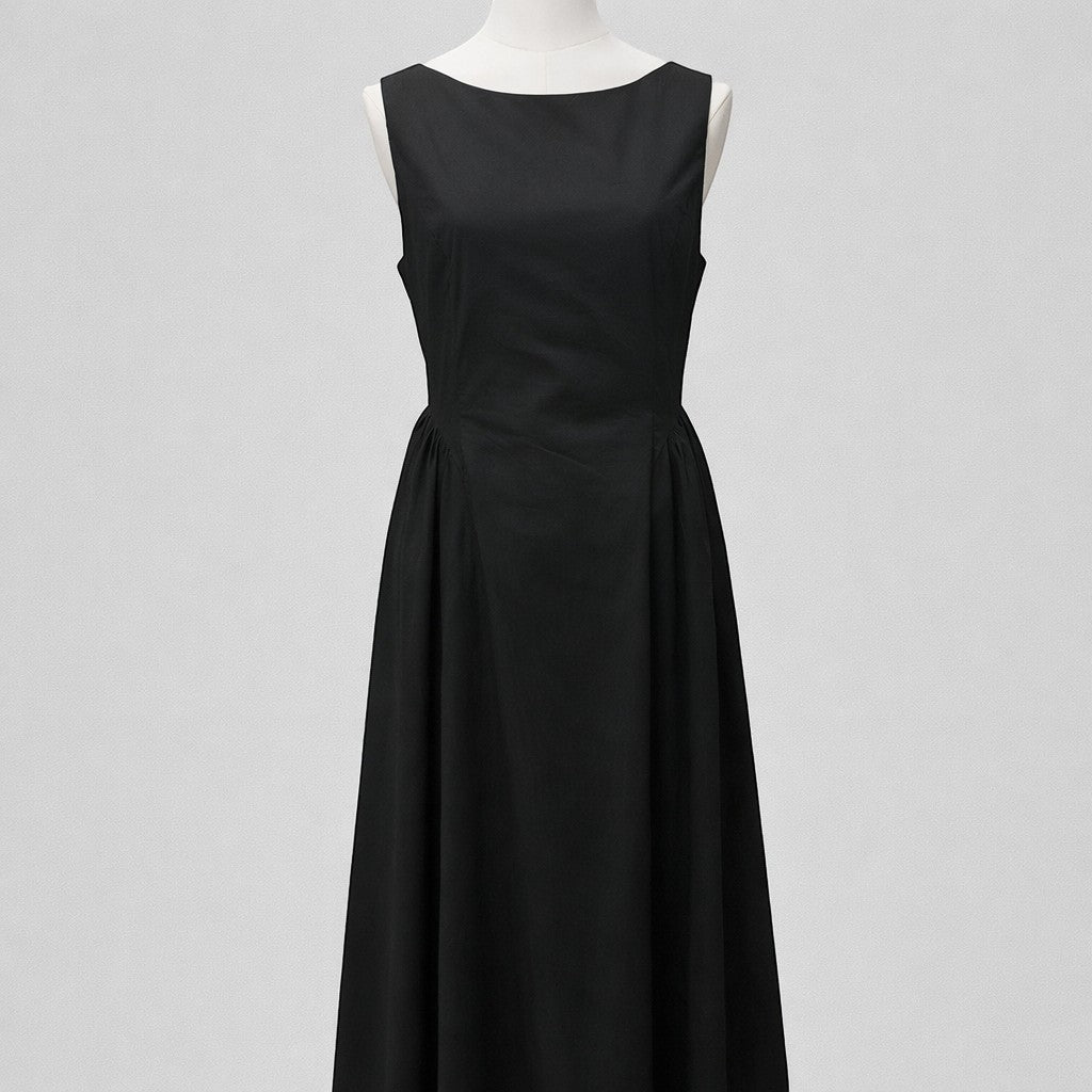 La Vie Continue timeless black 100% cotton sleeveless maxi dress with a boat neckline and flowing skirt.