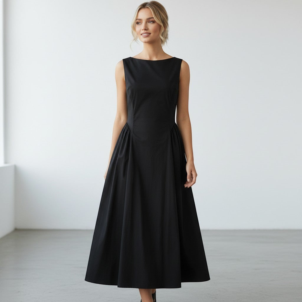 La Vie Continue black 100% cotton sleeveless midi dress with a boat neckline and full skirt, modelled by a blonde woman.
