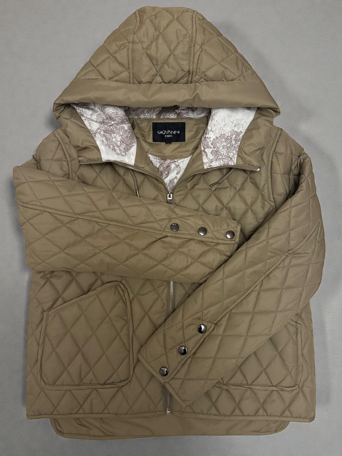 La Vie Continue khaki quilted jacket with diamond pattern, hood, and patterned lining.