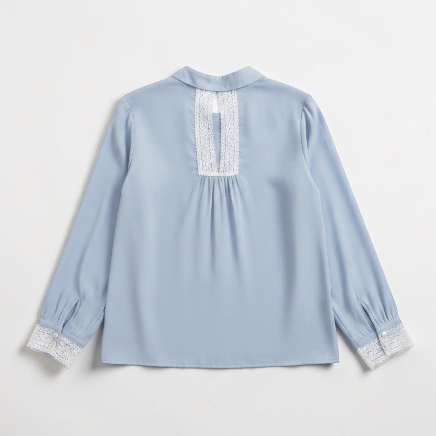 La Vie Continue light blue viscose-Tencel blend blouse with lace trim on collar and cuffs. Long sleeves with button detail.