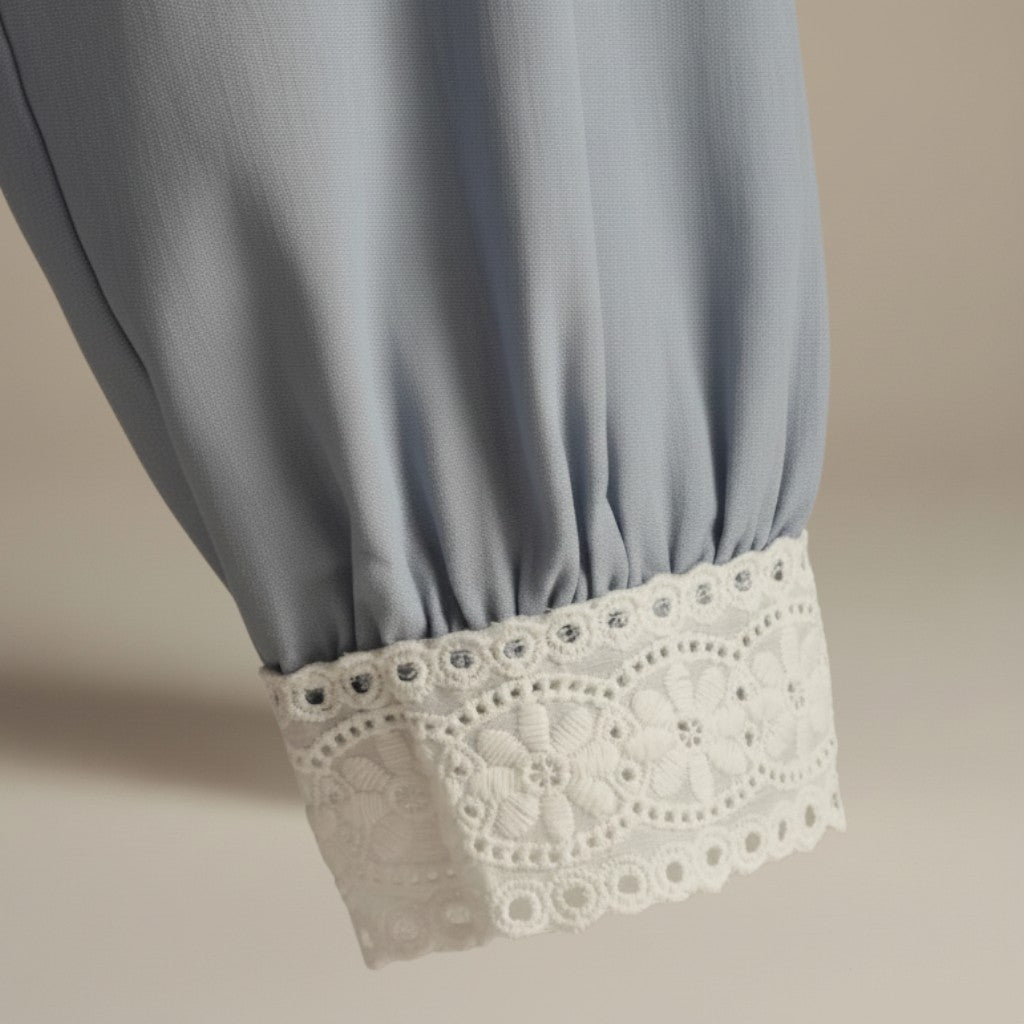 La Vie Continue light blue viscose-Tencel blend shirt with delicate white lace trim on the cuff.