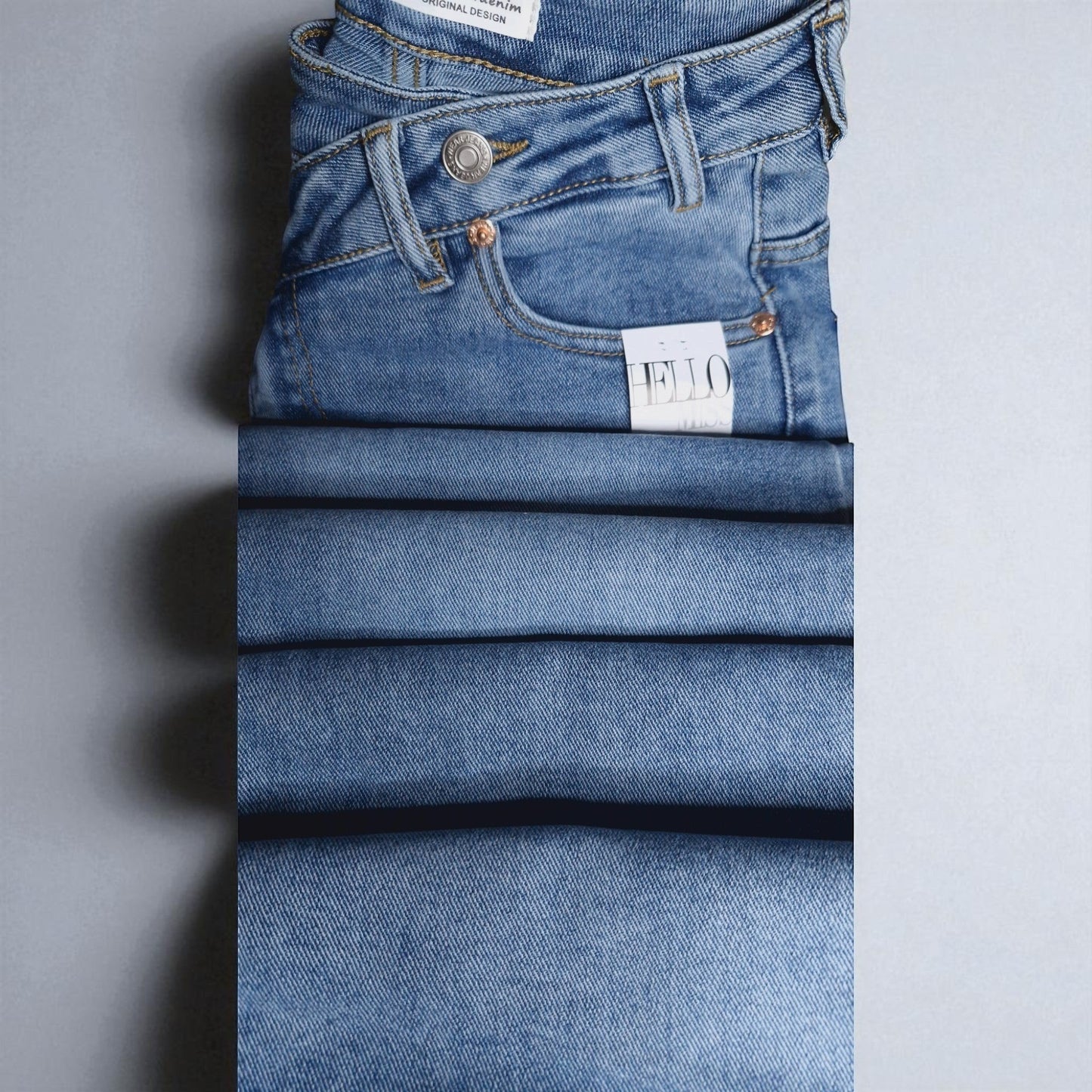 La Vie Continue light blue wide leg jeans with asymmetric button detail, made from cotton blend.